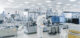 Shot of Sterile Pharmaceutical Manufacturing Laboratory where Scientists in Protective Coverall’s Do Research, Quality Control and Work on the Discovery of new Medicine.