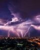 Lightning storm over city in purple light