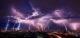 Lightning storm over city in purple light