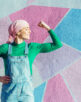 Portrait of woman with pink headscarf, has cancer. Show the arm as a signal of strength