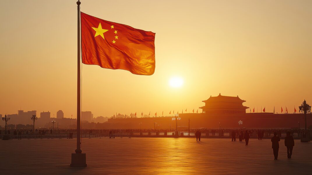 Chinese flag waving at sunset near iconic landmark